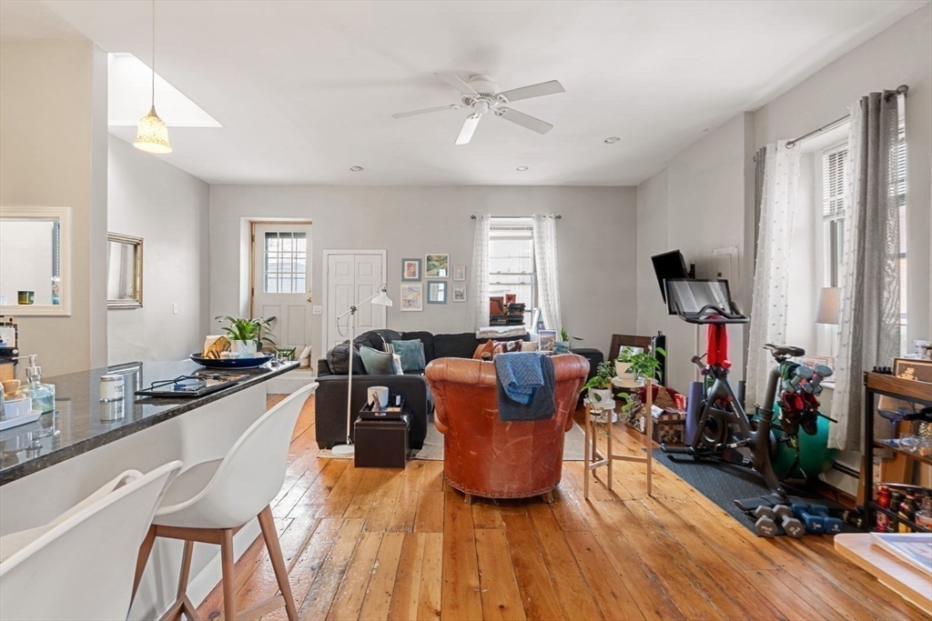 124 F Street Boston, MA 02127 - Photo 15 of 28 a living room with furniture a wooden floor and a window