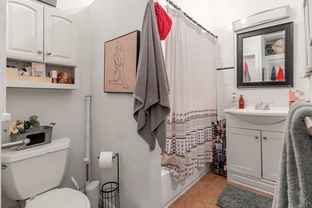 124 F Street Boston, MA 02127 - Photo 17 of 28 a bathroom with a toilet sink and mirror