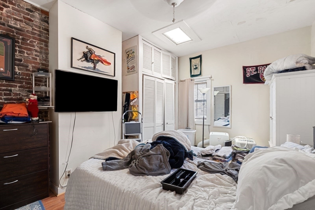 124 F Street Boston, MA 02127 - Photo 20 of 28 a living room with furniture a flat screen tv and a lamp