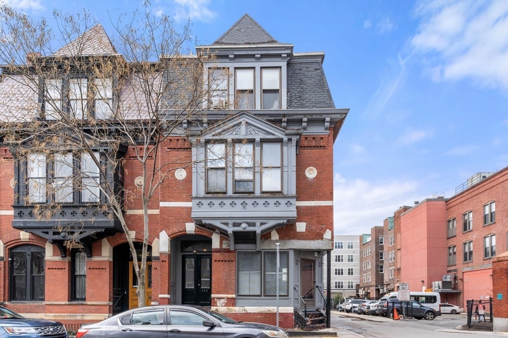 124 F Street Boston, MA 02127 - Photo 3 of 28 a front view of a residential apartment building with a yard