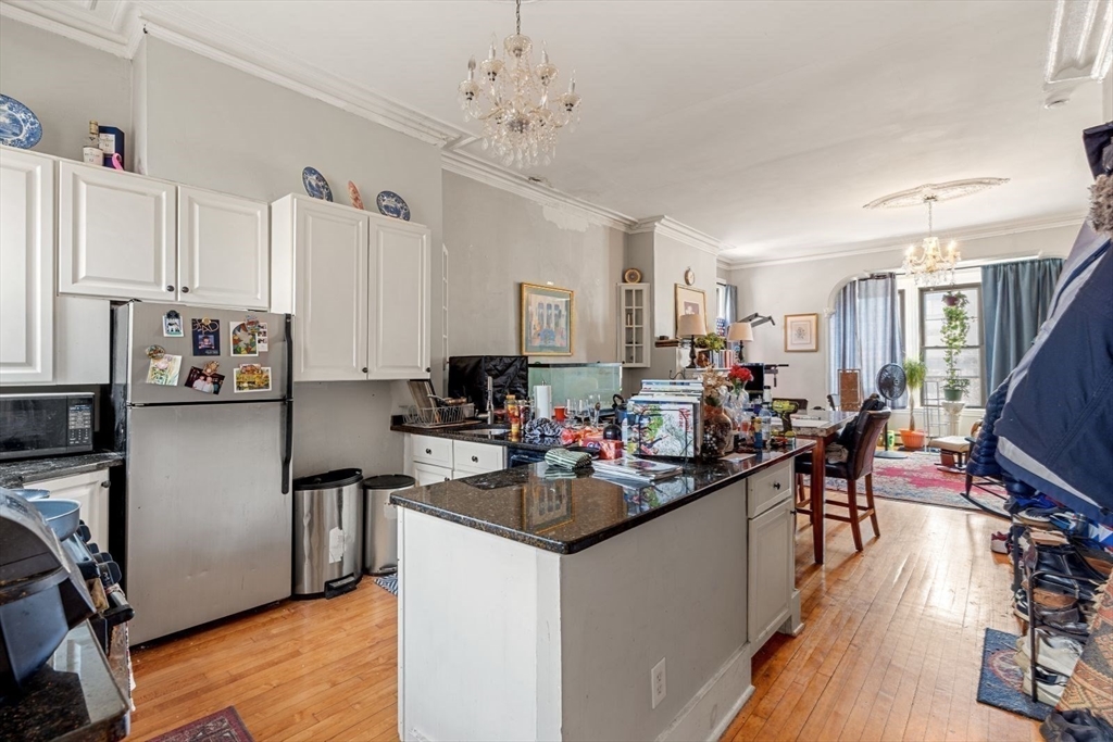 124 F Street Boston, MA 02127 - Photo 7 of 28 a kitchen that has a lot of cabinets a sink and appliances in it