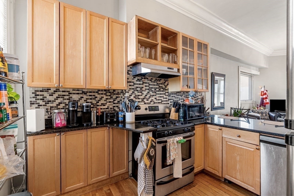 124 F Street Boston, MA 02127 - Photo 9 of 28 a kitchen with stainless steel appliances a stove a sink and a microwave