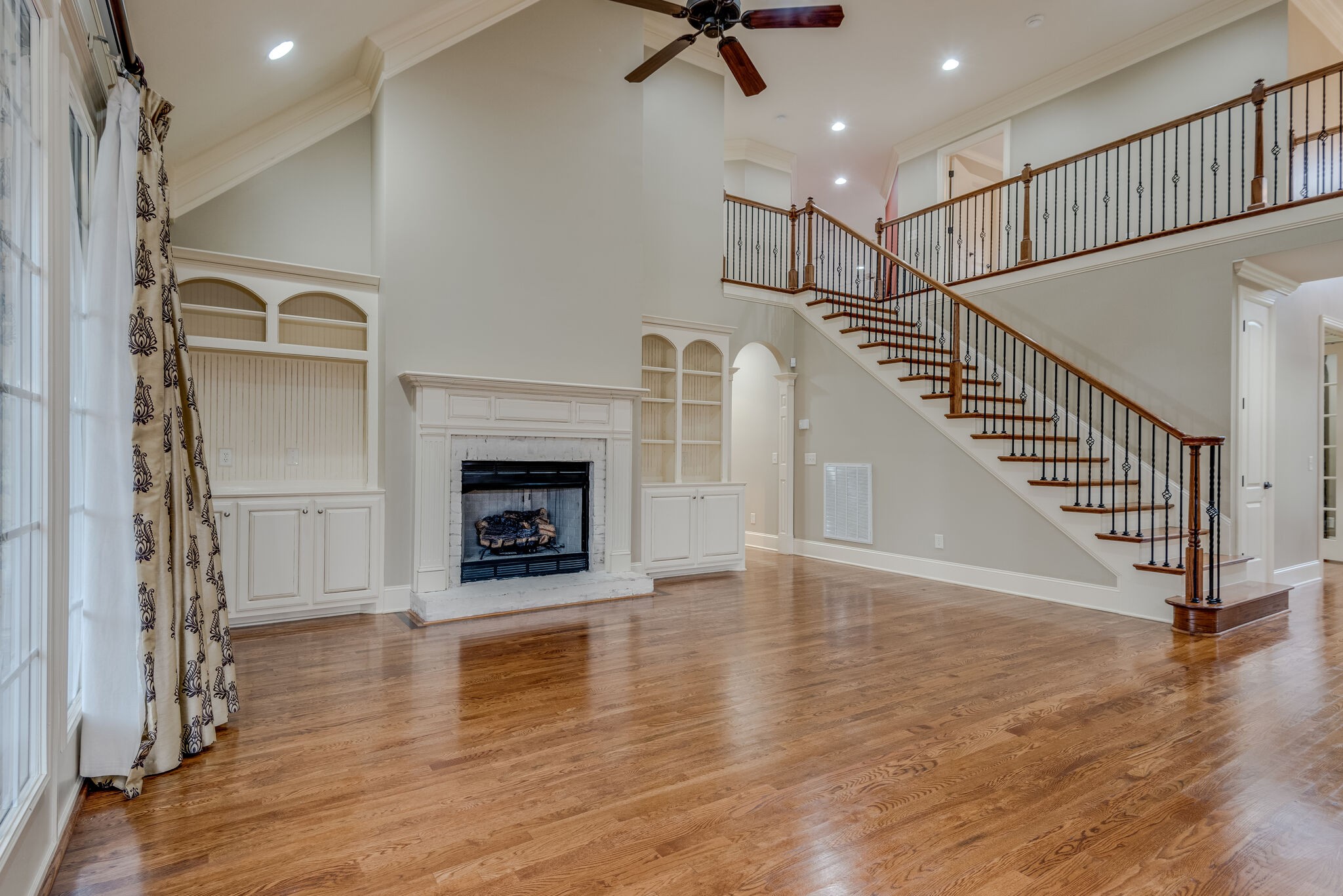 281 King Arthur Circle Franklin, TN 37067 - Photo 12 of 47 a view of a livingroom with wooden floor a fireplace and entryway