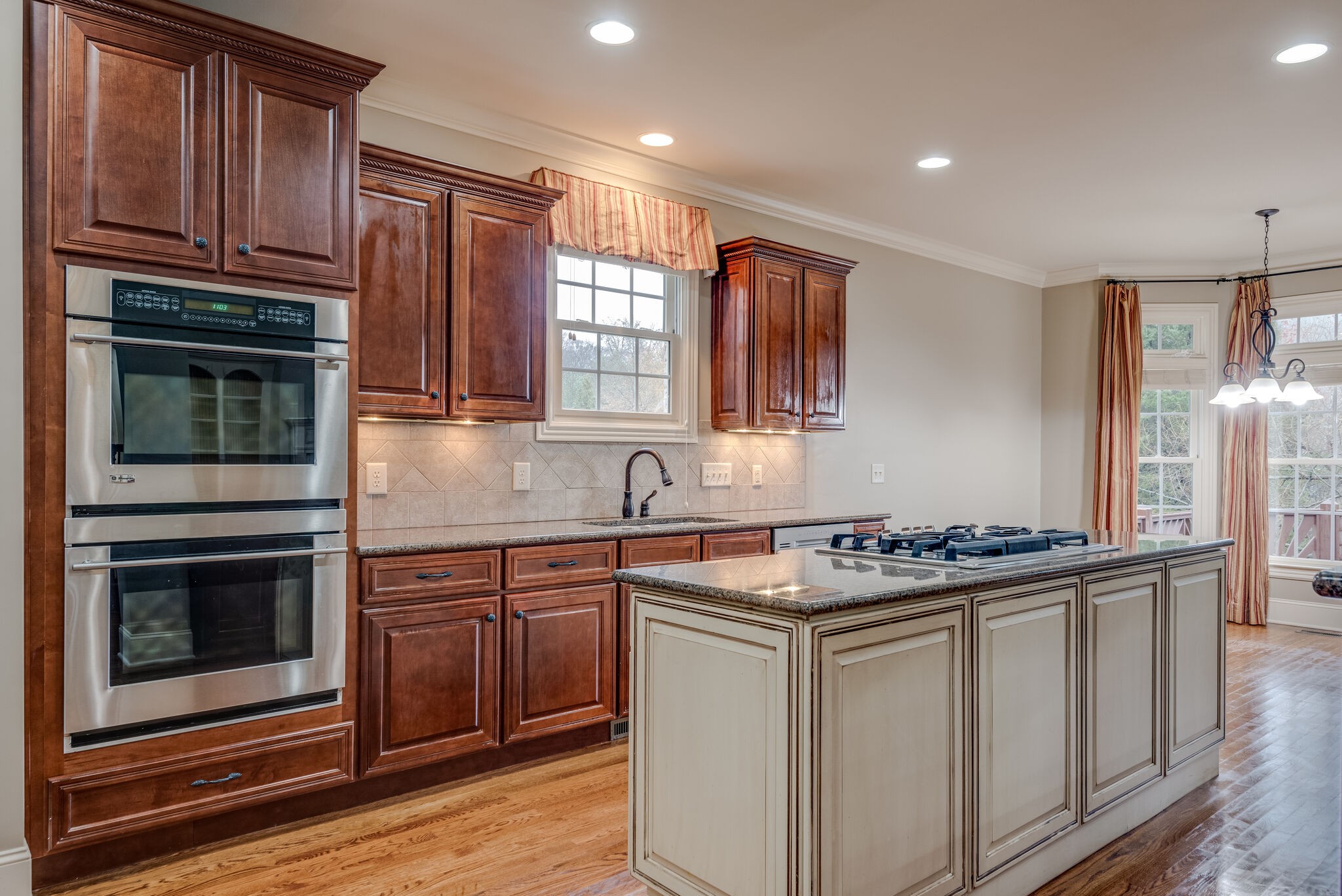 281 King Arthur Circle Franklin, TN 37067 - Photo 20 of 47 a kitchen with stainless steel appliances granite countertop a stove a sink and a microwave