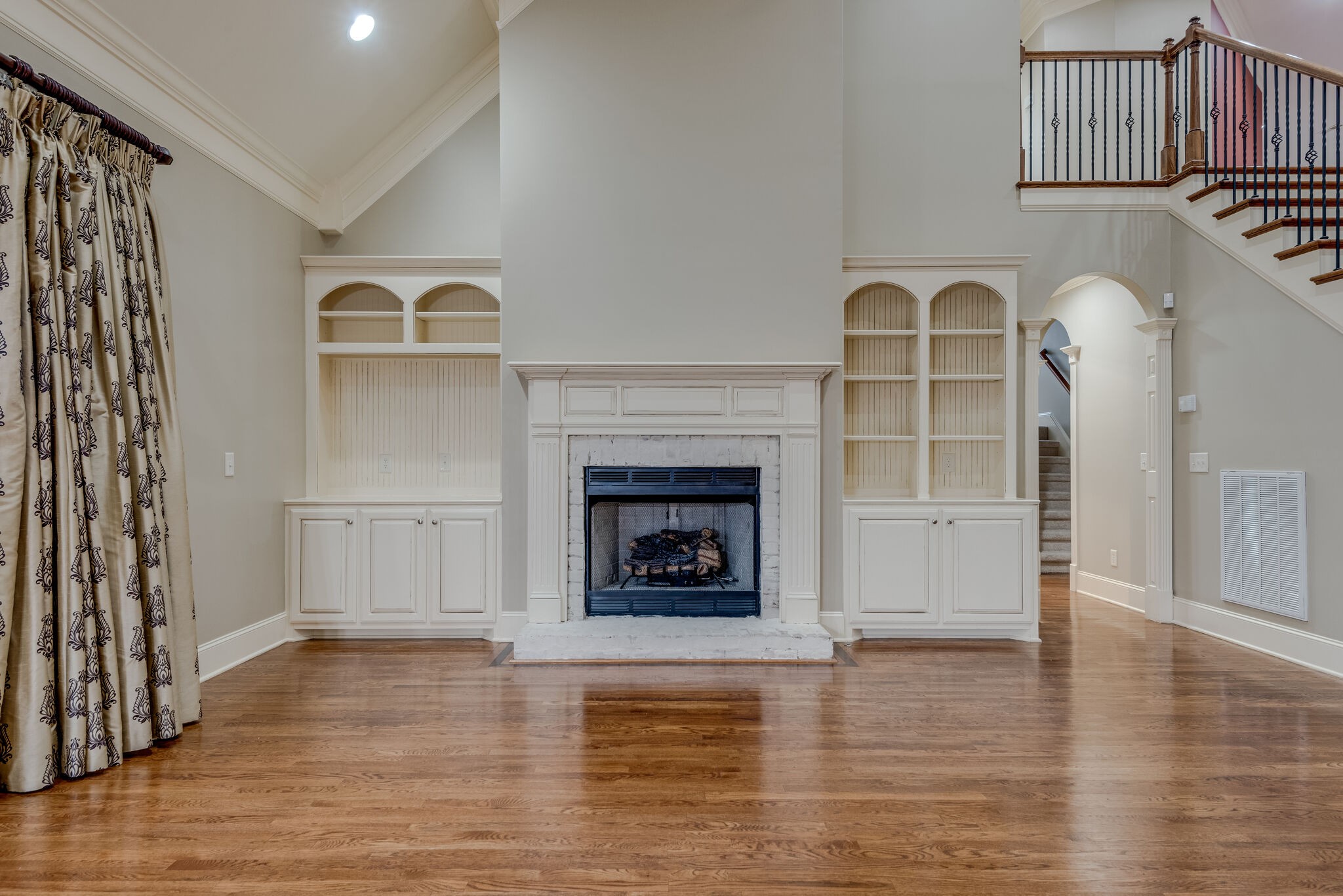 281 King Arthur Circle Franklin, TN 37067 - Photo 10 of 47 a view of an empty room with wooden floor fireplace and a window