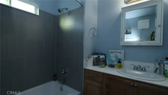 a bathroom with a sink vanity granite and toilet