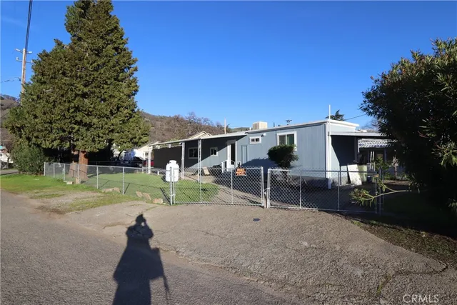 front view of a house with a yard and potted plants