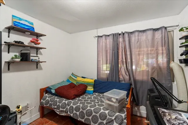 a bedroom with furniture and a window