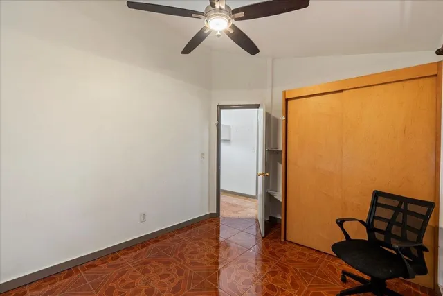 a view of room with hardwood floor and ceiling fan