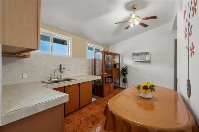 a view of a kitchen area with furniture and wooden floor