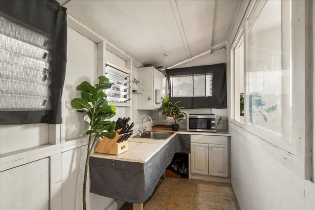 a kitchen with a sink stove and cabinets