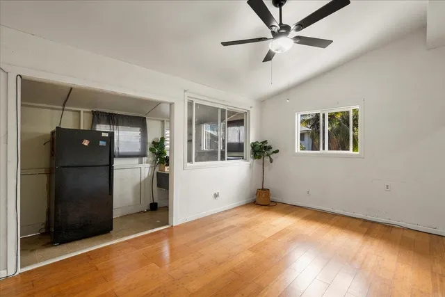a view of an empty room with window and cabinet