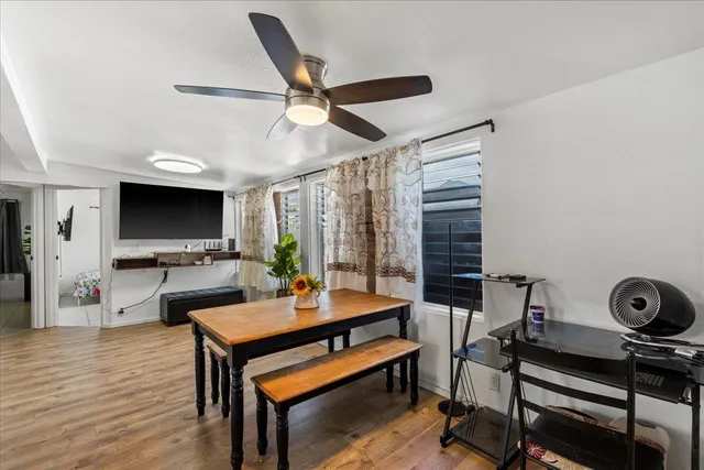 a living room with furniture a flat screen tv and a table