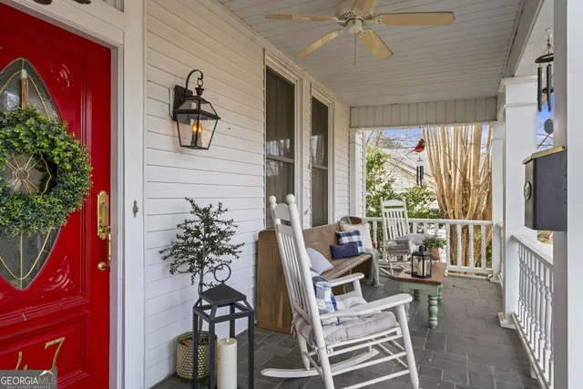 a living room with furniture a flat screen tv and a floor to ceiling window