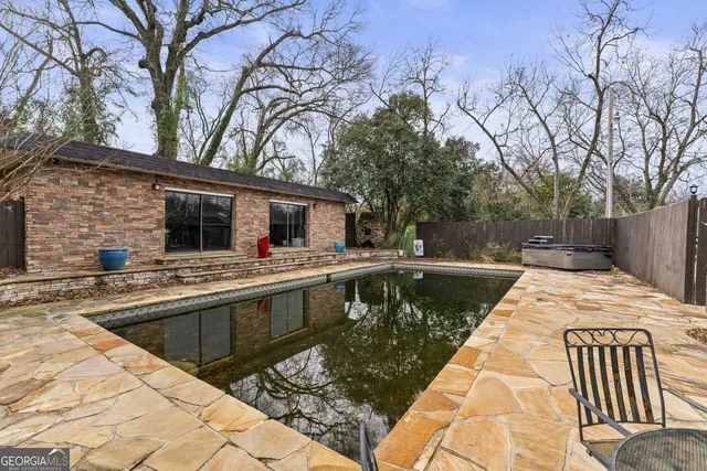 a view of a house with swimming pool and sitting area