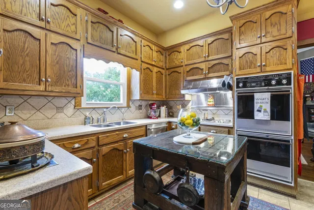 a kitchen with appliances cabinets and a window