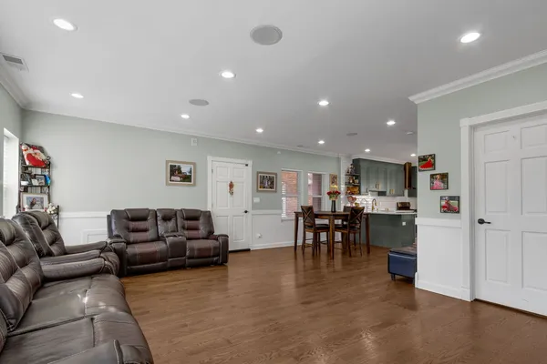 a living room with furniture and a kitchen view