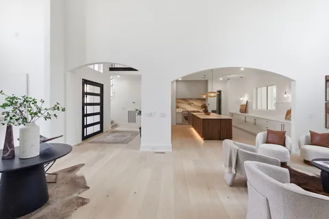 a kitchen with kitchen island granite countertop a sink counter top space appliances and a window