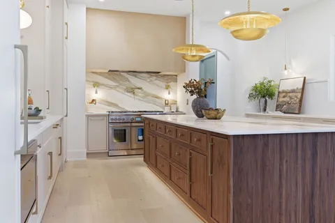 a kitchen with cabinets a sink and wooden floor