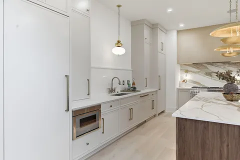 a stove top oven sitting inside of a kitchen