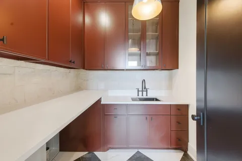 a spacious bathroom with a granite countertop sink and a mirror