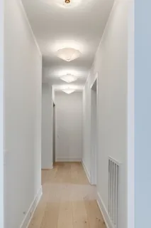a bathroom with a granite countertop tub shower and mirror