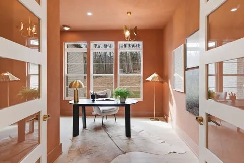 a bathroom with a tub shower and window