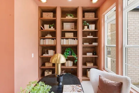 a kitchen with cabinets and wooden floor