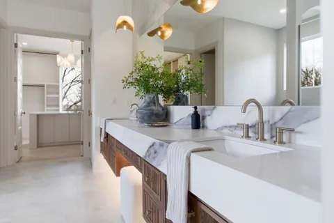 a bathroom with a toilet a sink and mirror