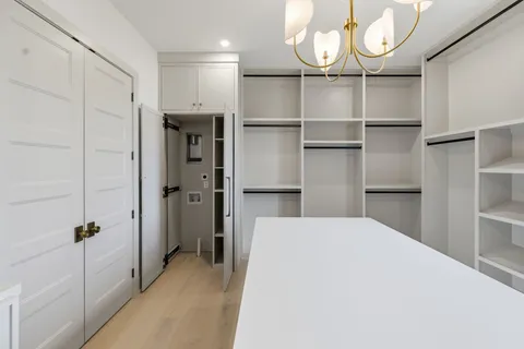 a view of walk in closet with empty racks