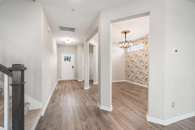 a view of hallway with wooden floor