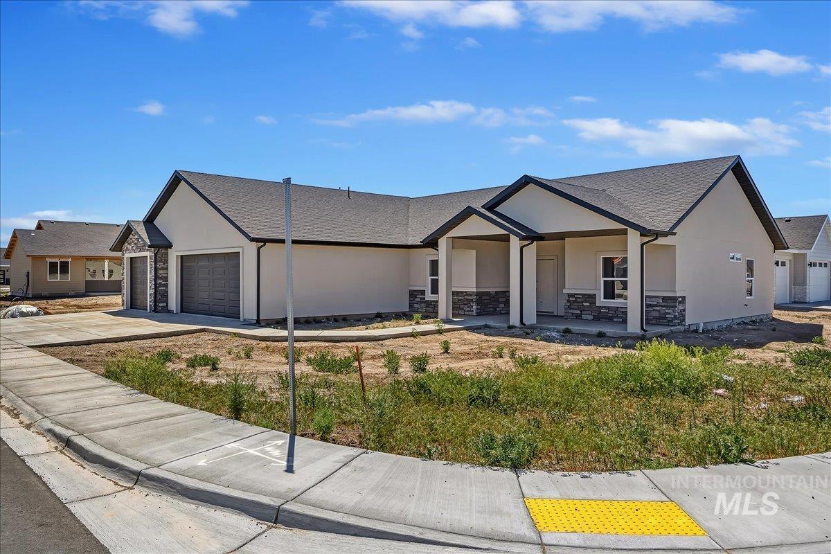 1119 Sage Rupert, ID 83350 - Photo 2 of 4 Contemporary single-story residence featuring a stucco exterior with stacked stone accents
