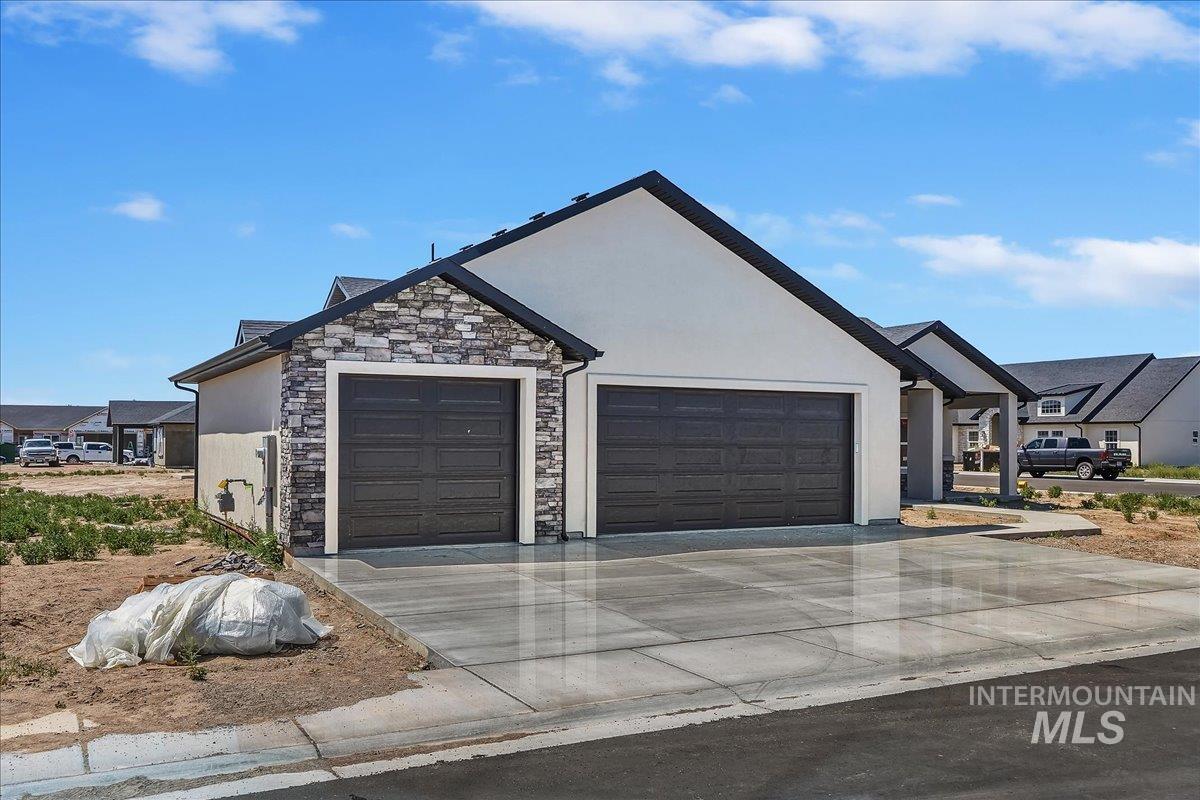 1119 Sage Rupert, ID 83350 - Photo 3 of 4 Contemporary exterior featuring a two-car garage and an additional single-car garage with dark paneled doors