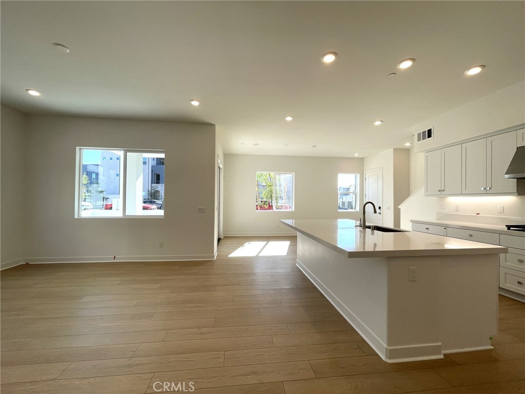 141 Baluster Irvine, CA 92618 - Photo 11 of 40 a living room with stainless steel appliances kitchen island granite countertop a sink and cabinets