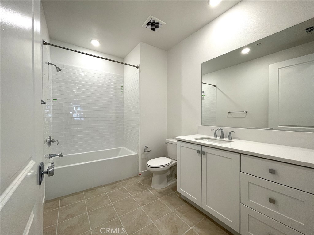 141 Baluster Irvine, CA 92618 - Photo 19 of 40 a bathroom with a double vanity sink toilet mirror and bathtub