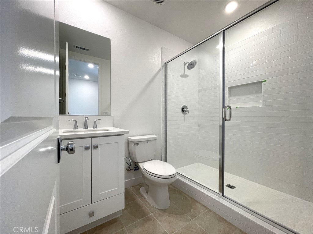 141 Baluster Irvine, CA 92618 - Photo 28 of 40 a bathroom with a double vanity sink toilet and shower
