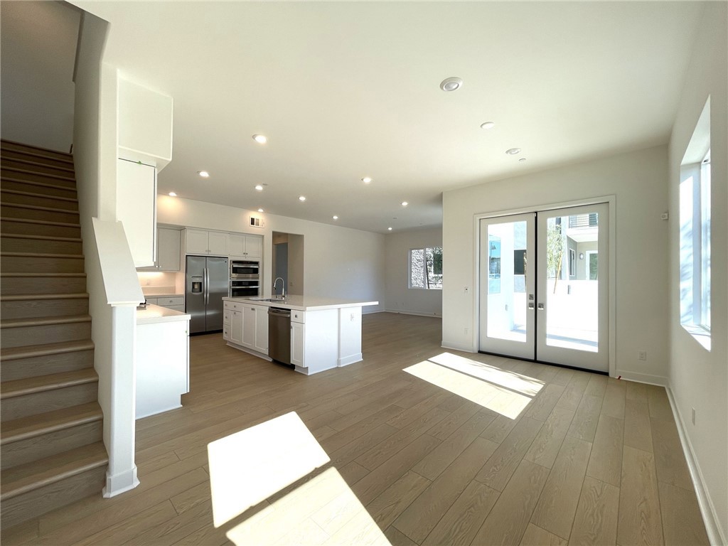 141 Baluster Irvine, CA 92618 - Photo 4 of 40 a view of kitchen with furniture and wooden floor