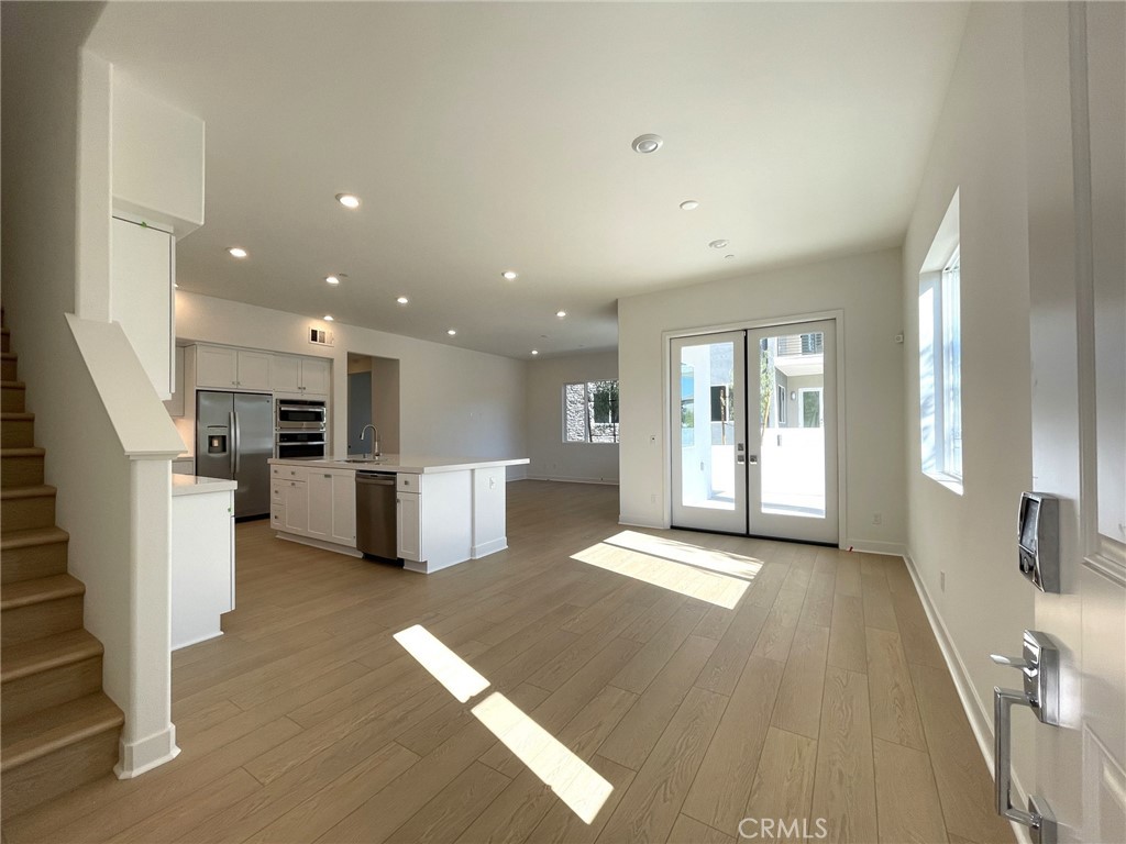 141 Baluster Irvine, CA 92618 - Photo 5 of 40 a view of a kitchen with furniture and wooden floor