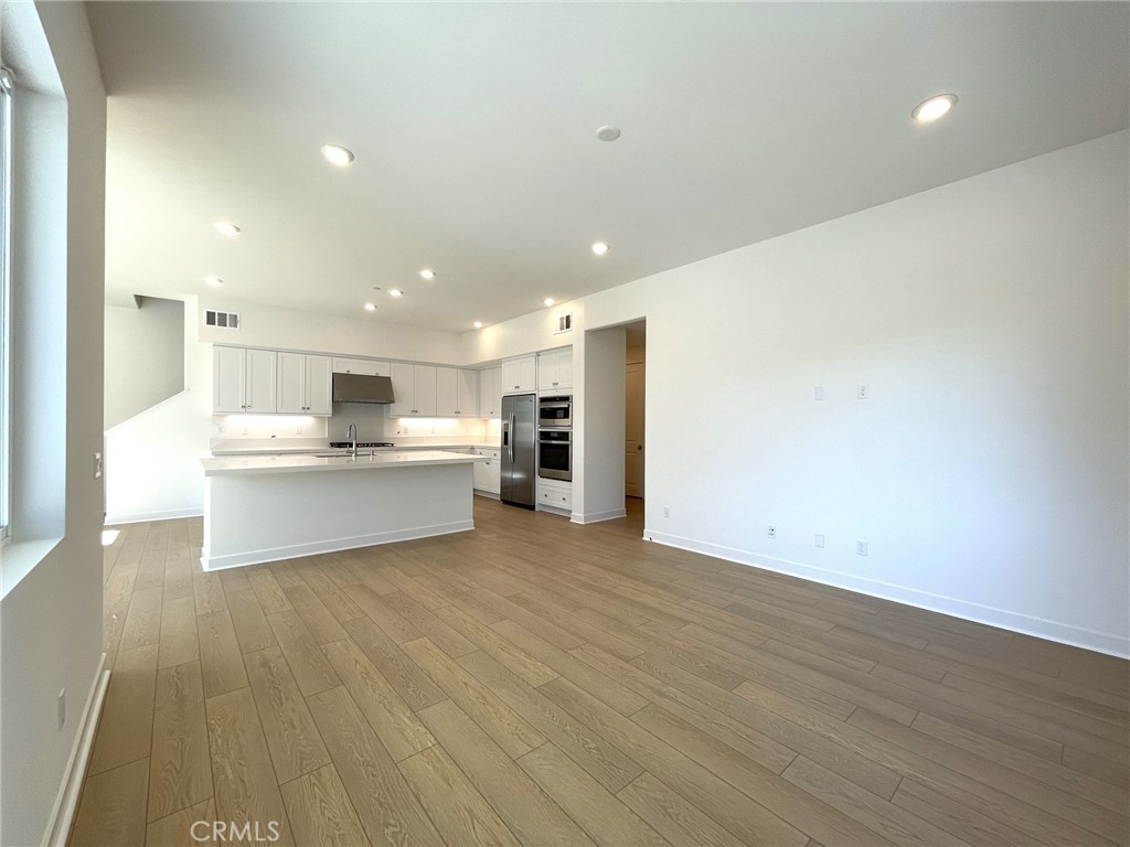 141 Baluster Irvine, CA 92618 - Photo 8 of 40 a view of kitchen with wooden floor