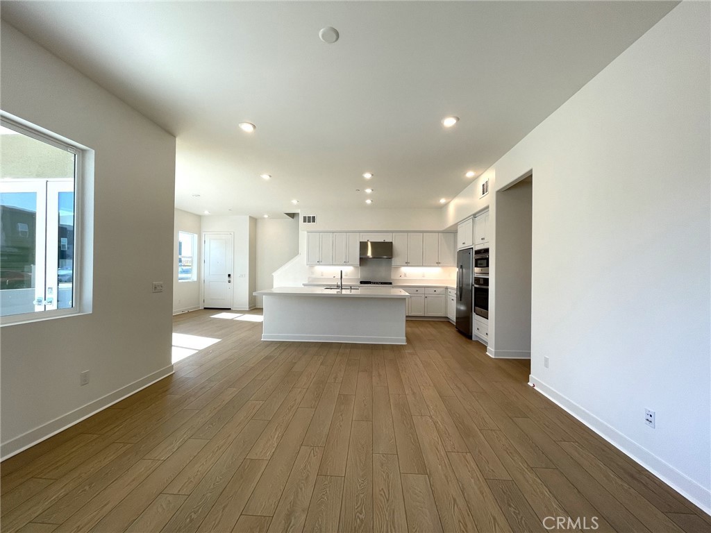 141 Baluster Irvine, CA 92618 - Photo 9 of 40 a view of a kitchen with wooden floor and windows