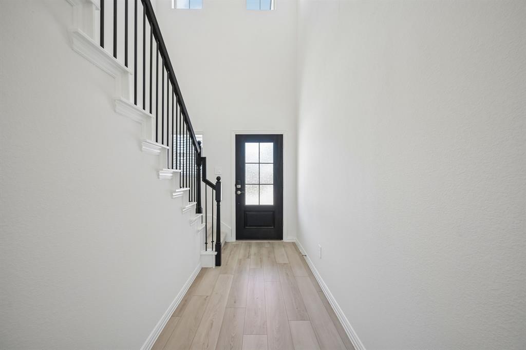 1705 Arches Road Anna, TX 75409 - Photo 5 of 33 a view of a hallway with wooden floor and entryway