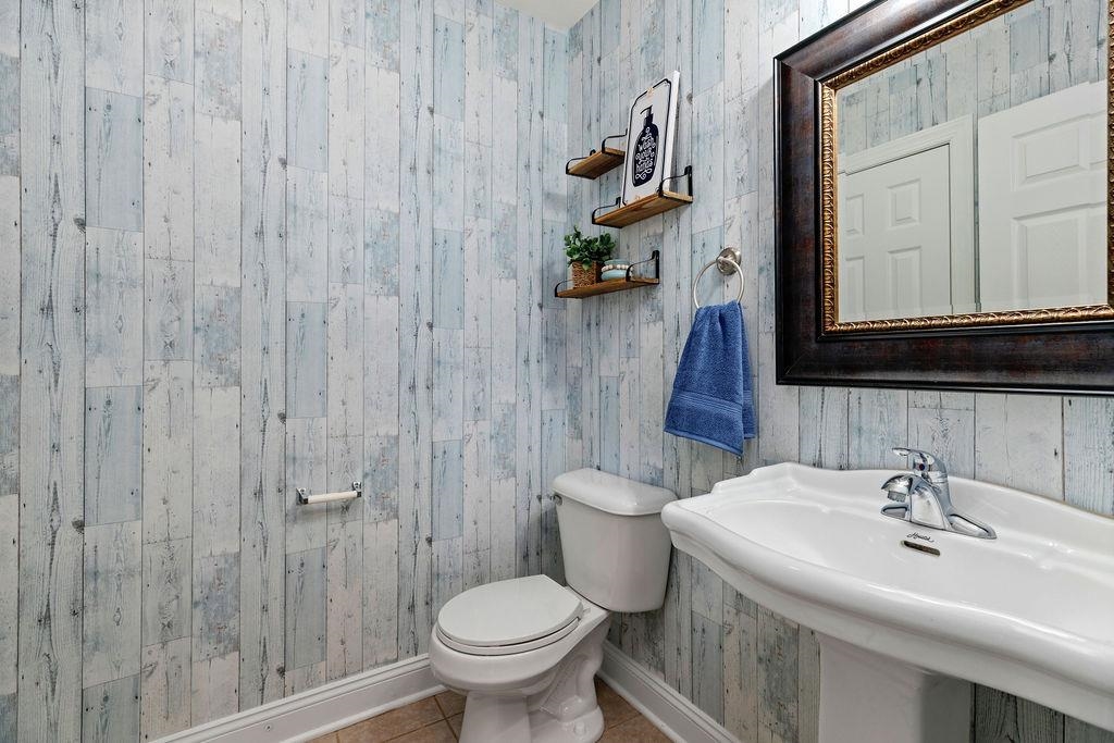 1916 Tinkling Spring Road Stuarts Draft, VA 24477 - Photo 23 of 66 a bathroom with a toilet sink and mirror