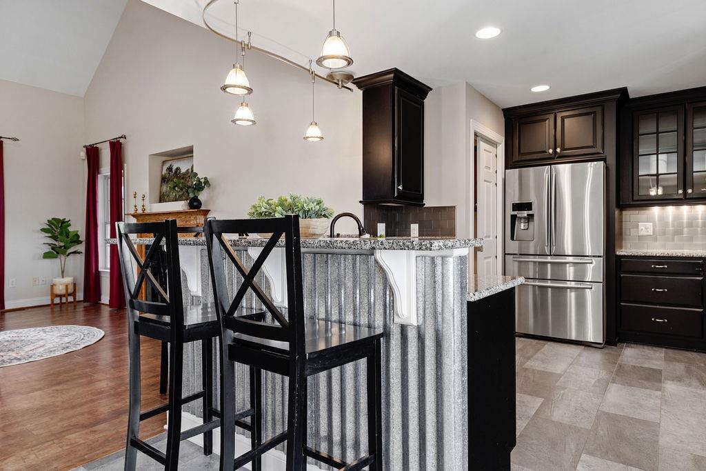 1916 Tinkling Spring Road Stuarts Draft, VA 24477 - Photo 28 of 66 a kitchen with stainless steel appliances granite countertop a refrigerator a stove and a dining table with wooden floor
