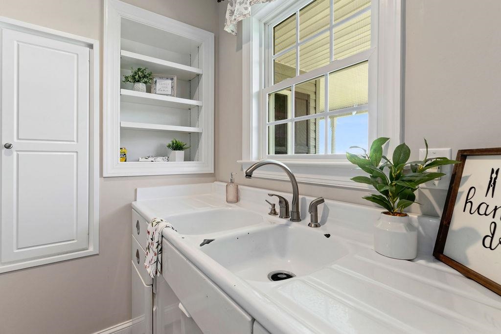 1916 Tinkling Spring Road Stuarts Draft, VA 24477 - Photo 35 of 66 a bathroom with a sink a potted plant and a window