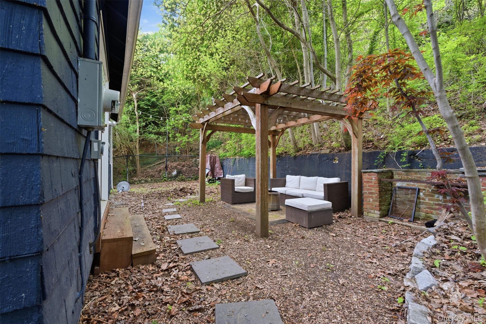 988 Rte 9W Nyack, NY 10960 - Photo 23 of 24 a view of a patio with table and chairs potted plants and large tree