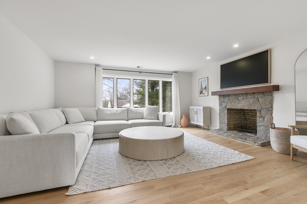 5 Crestwood Road North Reading, MA 01864 - Photo 11 of 40 a living room with furniture a flat screen tv and a fireplace