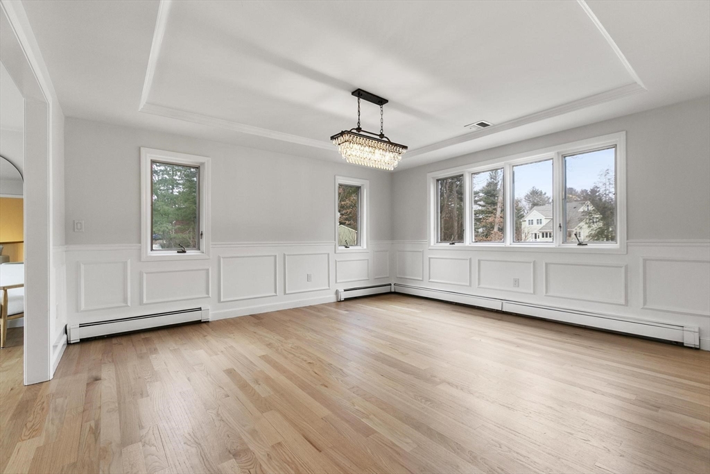 5 Crestwood Road North Reading, MA 01864 - Photo 13 of 40 an empty room with wooden floor cabinet and windows