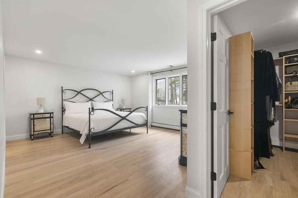 5 Crestwood Road North Reading, MA 01864 - Photo 15 of 40 a bedroom with a bed a table and painting