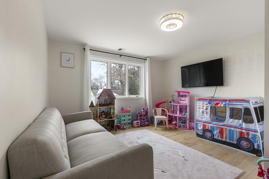 5 Crestwood Road North Reading, MA 01864 - Photo 20 of 40 a living room with furniture and a flat screen tv