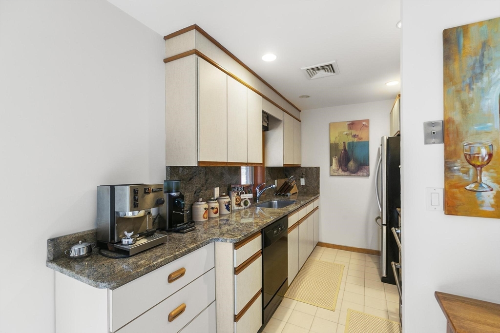 5 Crestwood Road North Reading, MA 01864 - Photo 28 of 40 a kitchen with stainless steel appliances granite countertop a sink stove and cabinets